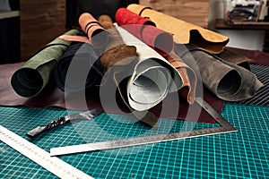 Artificial leather samples on a cow leather background. Top view.