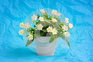 Artificial light yellow Primula (Primrose) flower in a ceramic flowerpot