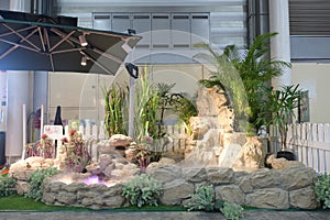 An artificial man made pond with water sprinkle and dry ice on display