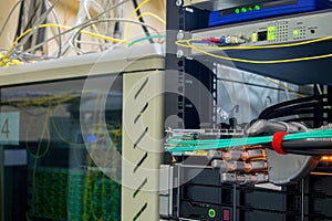 An artificial metal arm performs work in the server room. The robot switches the wires in the data center