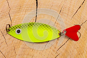 artificial metal baits on a wooden background. Homemade fishing gear. baits for catching large predatory fish. Items are made of