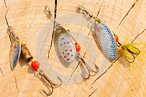 artificial metal baits on a wooden background. Homemade fishing gear. baits for catching large predatory fish. Items are made of