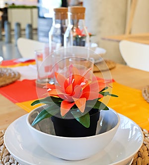 Artificial Plant with Orange Flower in Plastic Pot photo