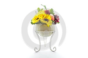 Artificial plastic flowers and fruits isolated on white background