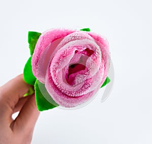 Artificial plush rose in hand