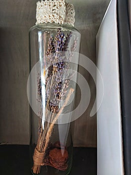 artificial purple flower in clear bottle looks aesthetically pleasing