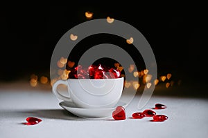 Artificial red hearts in a white Cup. Valentine`s day