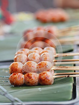 Artificial sausage Thai sausage casing cooking twine made from minced pork and rice take to grill put on green banana leaves