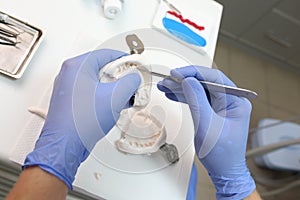 Artificial teeth, prosthetics, hands while working on the denture