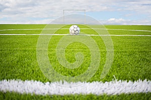 Artificial turf football field green on sky background