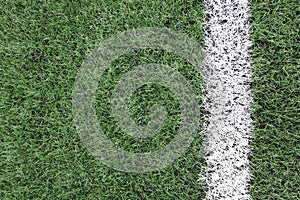 artificial turf with a white stripe close-up. copy space for text