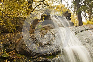 Artificial waterfall in autumn park