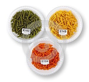 Artificially colored pasta in plates