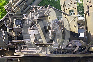 Artillery weapon. Old military cannon, closeup. Military background with elements of artillery weapons in camouflage green