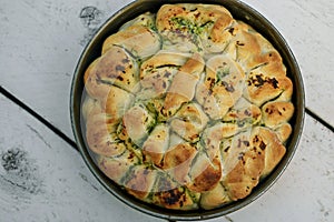 Artisan bread with different herbs. Fresh baked bread in cake form.