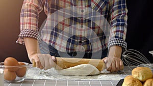 Artisan bread working with dough. Flour dusting on dough, handmade bread dough rolling and kneading in kitchen with bakery