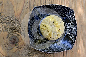 Artisan cheese with seeds in the shape of a flower on a plate