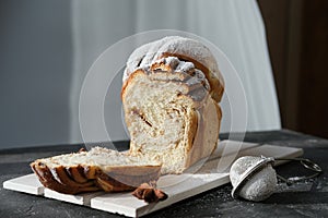 Artisan cinnamon swirl bread on wooden rack