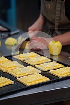 Artisan confectioner prepares homemade apple pie in a confectionery photo