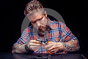 Artisan cutting leather outlines for his new production