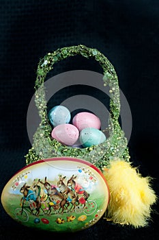 Artisan Easter basket of colored eggs and a papier-mÃ¢chÃ© egg with rabbit