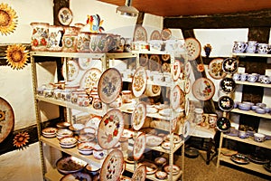 Artisan handmade ceramic plates and potties in a small shop photo