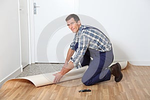 Artisan putting new flooring photo