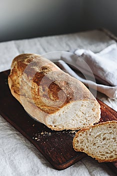 Artisan sourdough bread on wooden cutting board. Selective focus