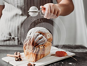 Artisan sourdough cinnamon swirl bread on wooden rack