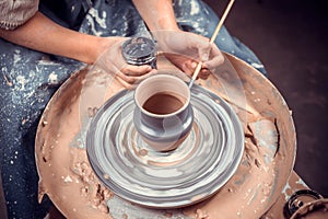 Artisan woman works with clay on a potter& x27;s wheel. Ceramics art concept. Close-up.