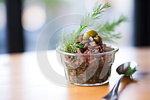 artisanal olive tapenade in a small glass container