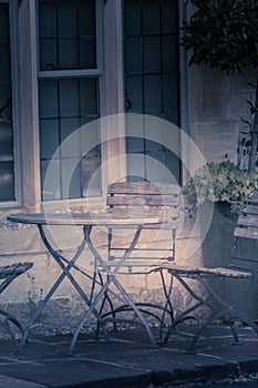 Artisitc metal table and chair in a garden UK