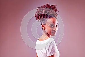 Artisitic red toned portrait of an attractive young Black woman photo