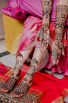 Artist applying henna tattoo on women hands.