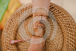 Artist applying henna tattoo on women hands. Mehndi is traditional Indian decorative art. Close-up