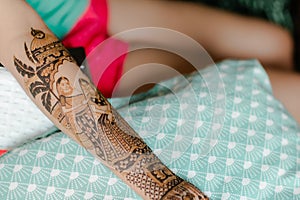 Artist applying henna tattoo on women hands. Mehndi is traditional Indian decorative art. Close-up