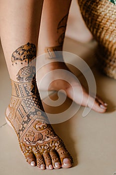 Artist applying henna tattoo on women hands. Mehndi is traditional Indian decorative art. Close-up