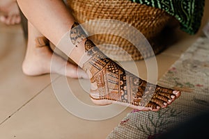 Artist applying henna tattoo on women hands. Mehndi is traditional Indian decorative art. Close-up