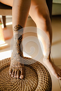 Artist applying henna tattoo on women hands. Mehndi is traditional Indian decorative art. Close-up