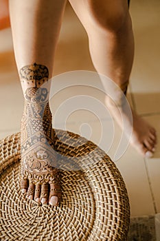 Artist applying henna tattoo on women hands. Mehndi is traditional Indian decorative art. Close-up