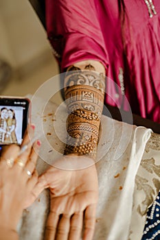 Artist applying henna tattoo on women hands. Mehndi is traditional Indian decorative art. Close-up