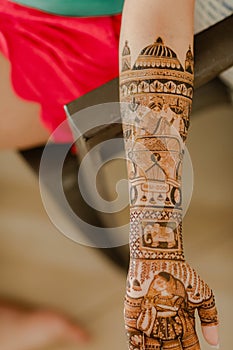 Artist applying henna tattoo on women hands. Mehndi is traditional Indian decorative art. Close-up