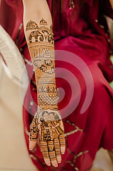 Artist applying henna tattoo on women hands. Mehndi is traditional Indian decorative art. Close-up