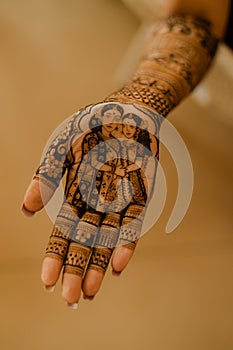 Artist applying henna tattoo on women hands. Mehndi is traditional Indian decorative art. Close-up