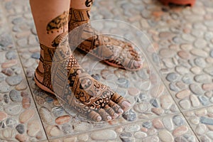 Artist applying henna tattoo on women hands. Mehndi is traditional Indian decorative art. Close-up