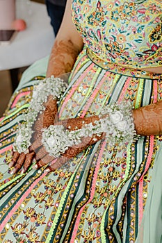 Artist applying henna tattoo on women hands. Mehndi is traditional Indian decorative art. Close-up