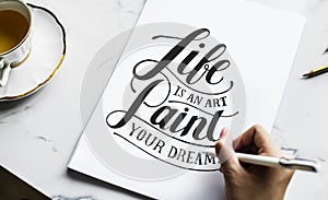 An artist creating hand lettering artwork