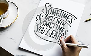 An artist creating hand lettering artwork