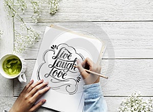 An artist creating hand lettering artwork from motivation quote