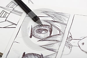 Artist drawing an anime comic book in a studio photo